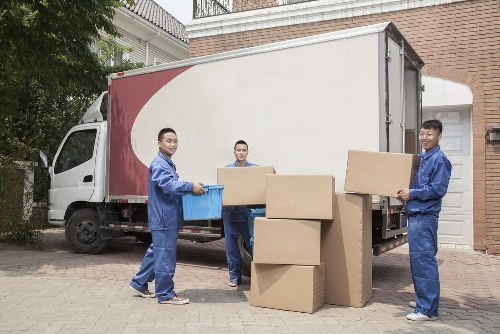 Storage site staff sorting cardboard and recyclable packaging for collection