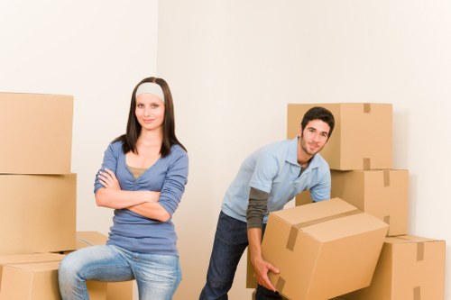 Professional movers preparing furniture for transport