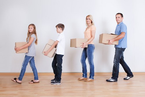 Employee following safe manual handling practices in storage